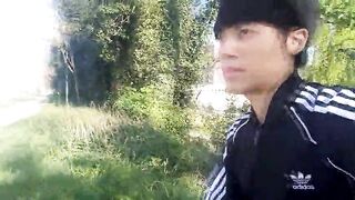 Freeballing in public, this twink walks outdoors commando, no underclothes underneath his ebony Adidas tracksuit, Campus sneakers, during the time that out cruising