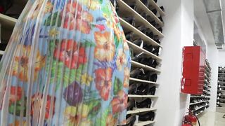 Voyeur spying hot legs and large butt below the petticoat in a public shoe store.