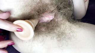 Hirsute hotty screws her juicy large love button vagina with sextoy in close up