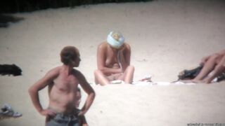 Excited undressed brunette hair woman teasing her fellows on the beach