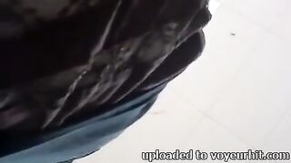 UPSKIRT--slender oriental with a bulky vagina peeking thru