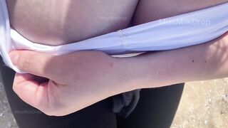 Hand expressing breastmilk at the beach!