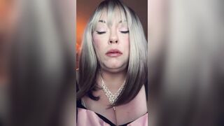 big beautiful woman Golden-haired Tina Snua Smokes A Slender Cigarette In A Holder In Satin Gloves With Rings