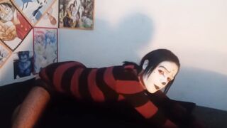 Gothic femboy in constricted costume and underware shows off her butt