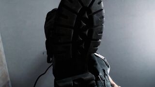 Feet fastened taut below coarse military boots